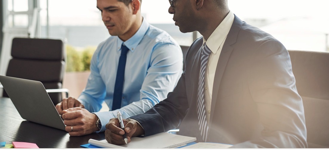 Two business professionals reviewing documents together.